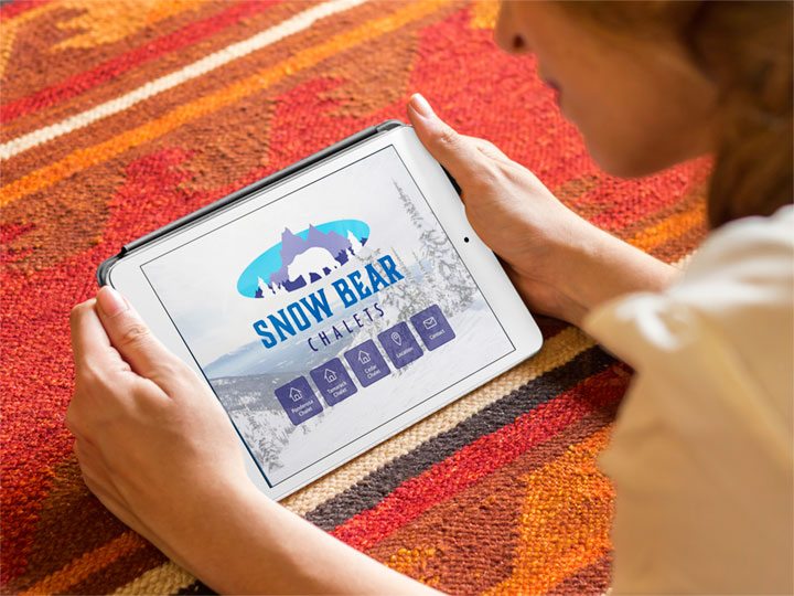 Snow Bear Chalets website viewed on an iPad tablet.