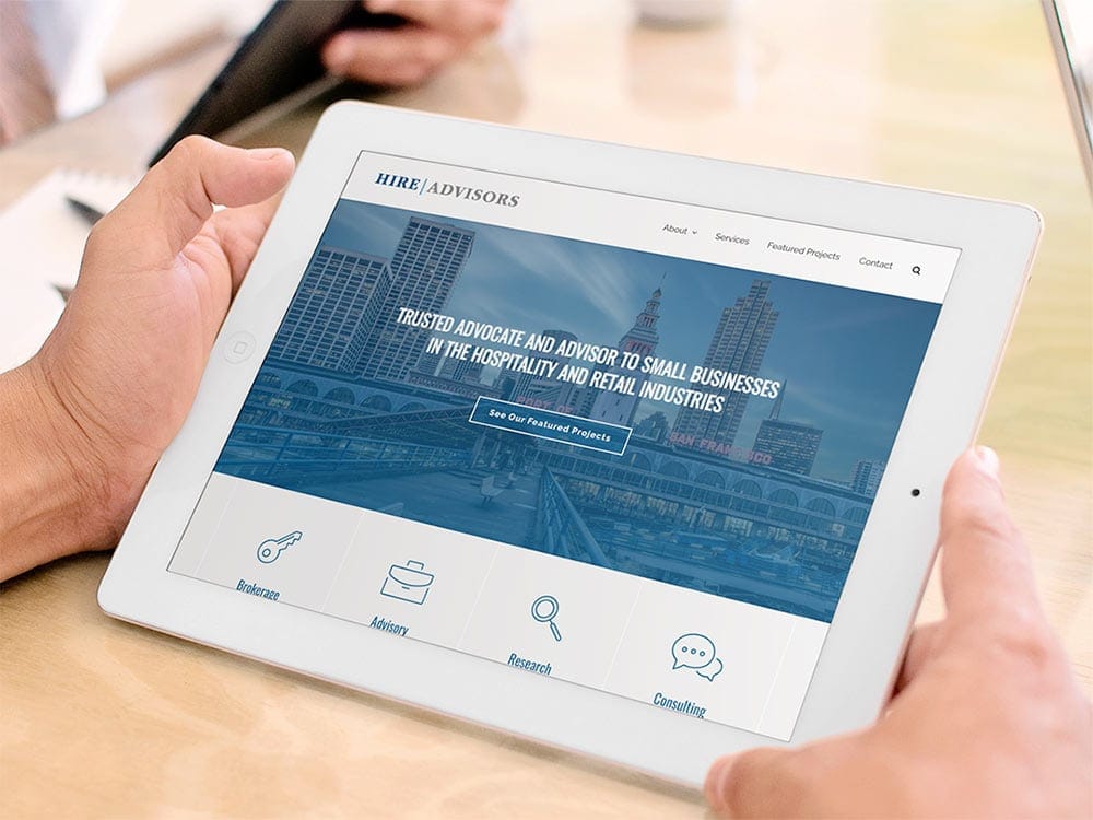 HIRE Advisors website viewed on a white iPad.